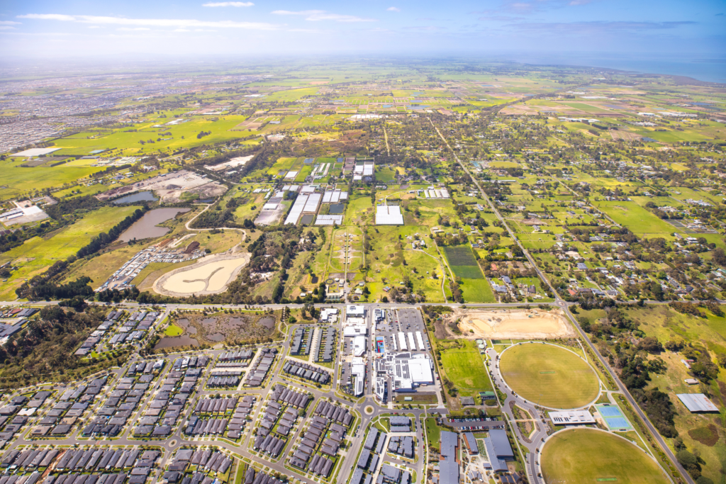 Aerial view over Junction Village, the Devon Meadows shops and the football and netball club, looking towards the Devon Meadows Estate land in Melbourne’s south east