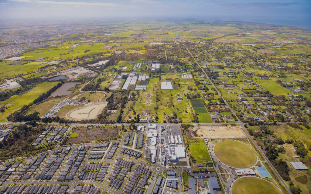 Aerial view over Junction Village, the Devon Meadows shops and the football and netball club, looking towards the Devon Meadows Estate land in Melbourne’s south east